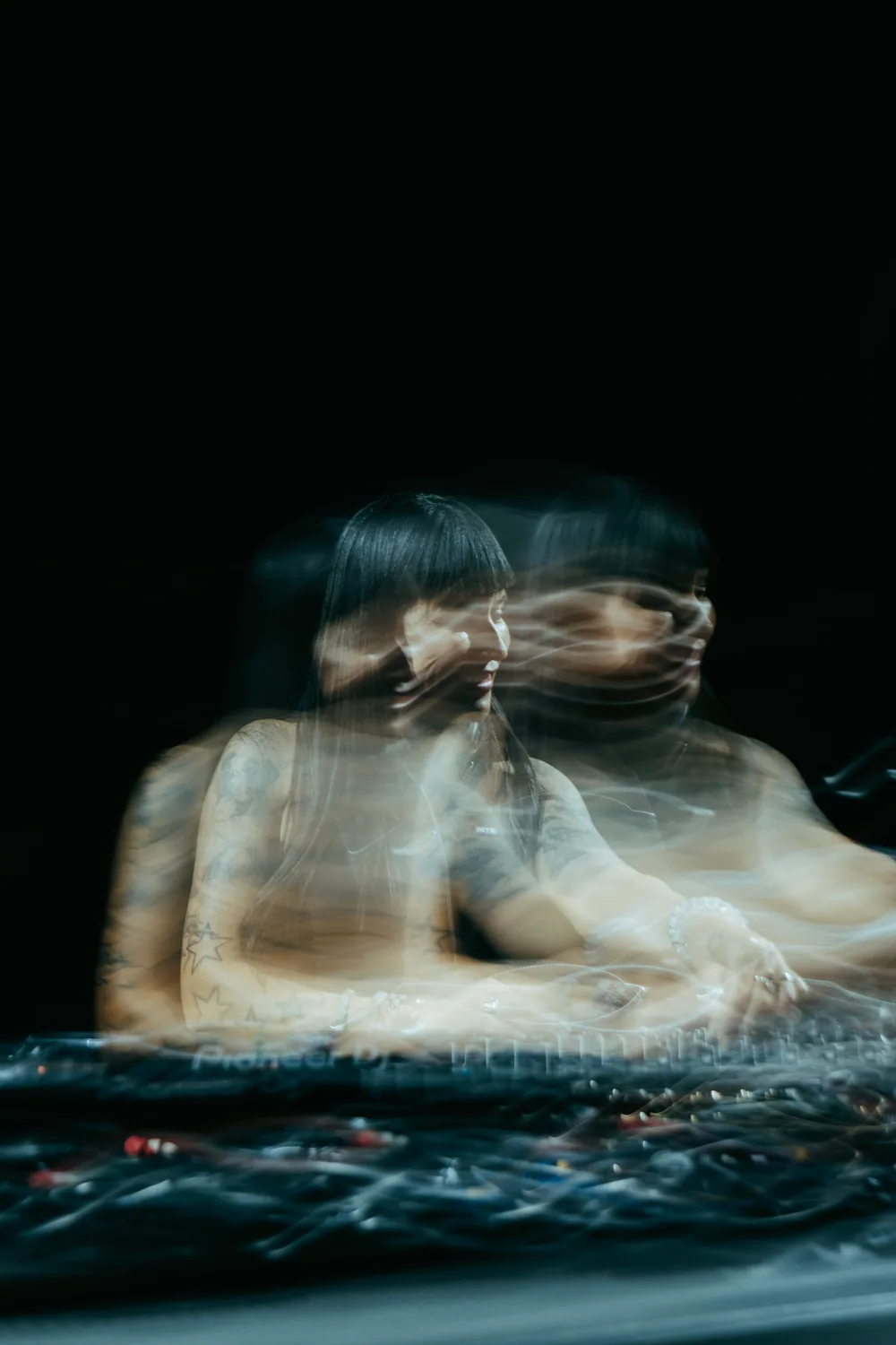 A long-exposure photograph tracing Fatima’s movement behind the decks