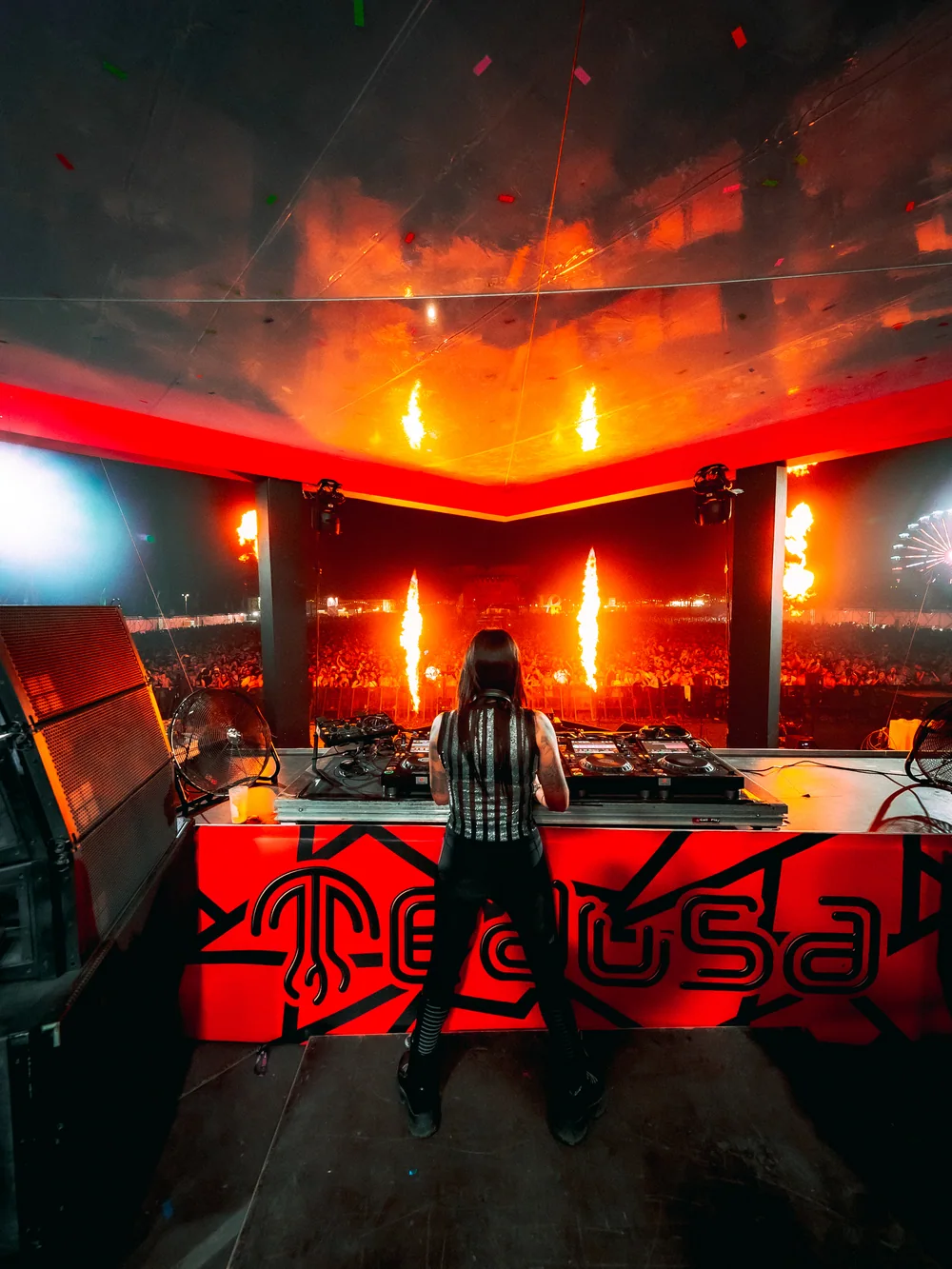 Fatima seen from behind at Blackworks, surrounded by intense red stage lighting